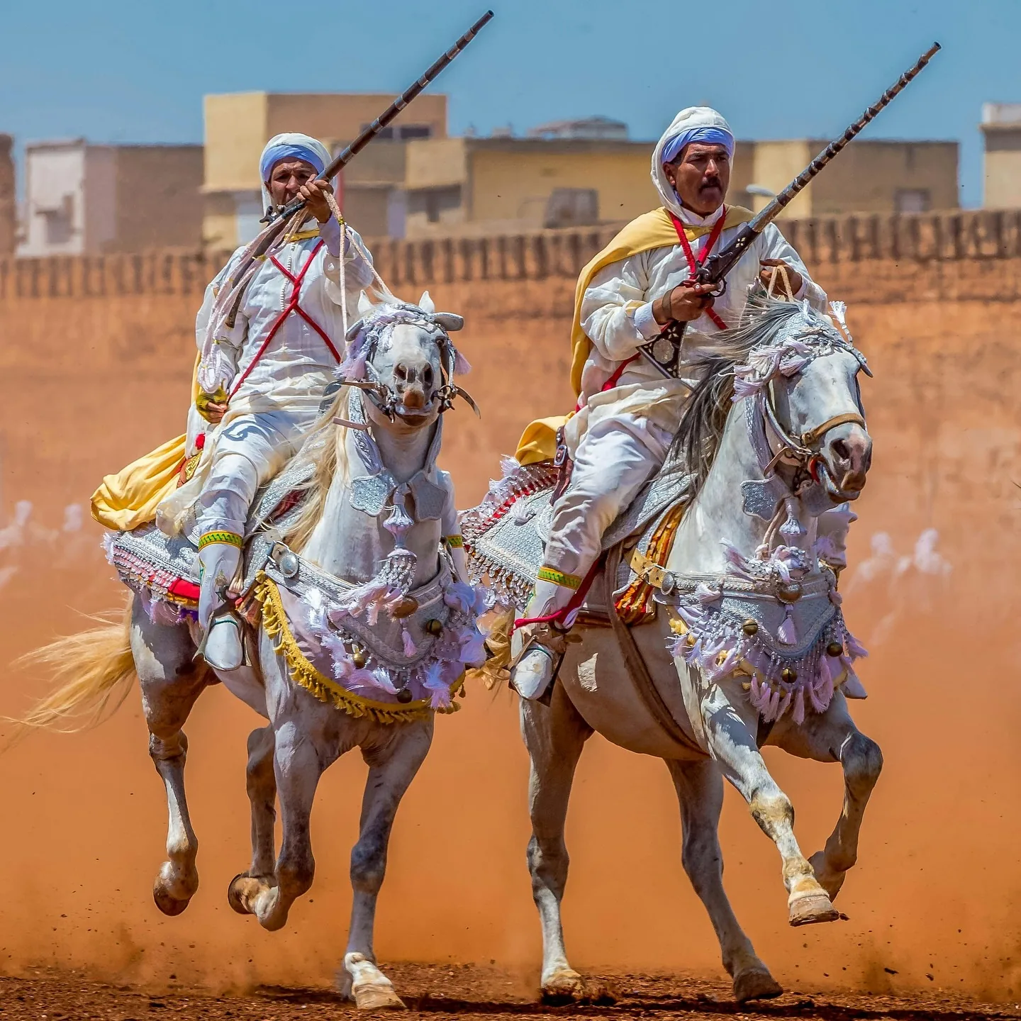 Traditional Moroccan horsemen performing Fantasia on horseback