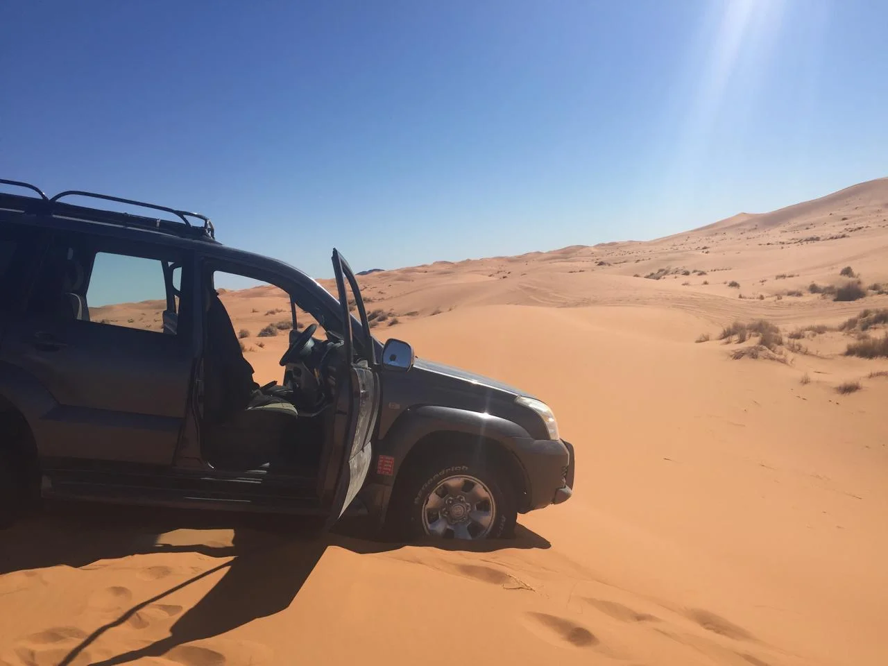 4x4 vehicle driving through the Sahara dunes in Morocco