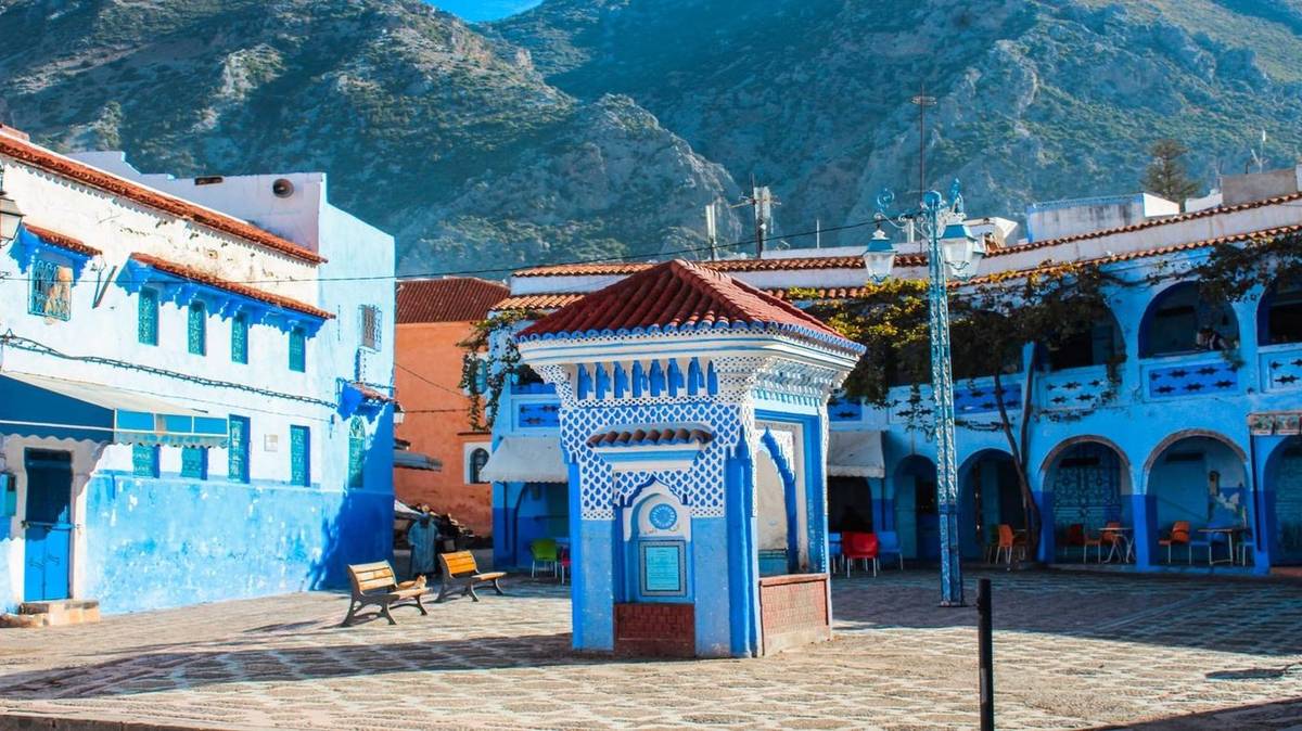 Blue gateway and mountain backdrop in Chefchaouen